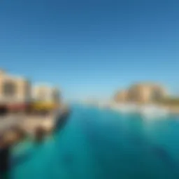 A stunning view of the Corniche Al Qawasim waterfront with pristine beaches and clear blue skies.